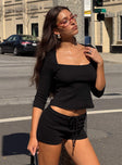 side view of model wearing Princess Polly Gracious Low Rise Mini Short Black Low Rise Shorts