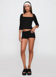 side view of model wearing Princess Polly Gracious Low Rise Mini Short Black Low Rise Shorts 